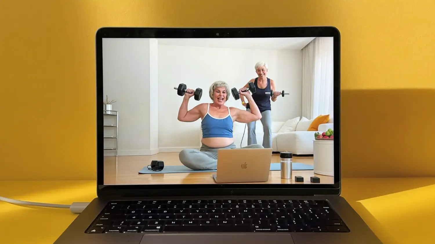 Laptop showing an online training session between a coach and a client